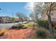 Landscaped grassy area with trees and a bench at 7822 Shingle Beach St, Las Vegas, NV 89166