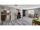 Bright living room featuring wood-look floors and a view into the kitchen at 1829 Sweeney Ave, Las Vegas, NV 89104