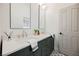 Elegant bathroom with double vanity, quartz countertop and green cabinets at 2499 Serenity Hollow Dr, Henderson, NV 89052