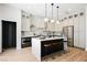 Modern kitchen with two-toned cabinetry, large island, and wine storage at 2499 Serenity Hollow Dr, Henderson, NV 89052