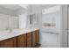 Double vanity bathroom with wood cabinets and a shower at 2540 Eclipsing Stars Dr, Henderson, NV 89044