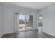 Living room with grey laminate floors and sliding doors to patio at 2540 Eclipsing Stars Dr, Henderson, NV 89044