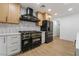 Modern kitchen with black and gold appliances at 3467 W Mardon Ave, Las Vegas, NV 89139