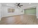 Bright and airy living room with an accent wall and wood-look floors at 3467 W Mardon Ave, Las Vegas, NV 89139