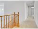 Upstairs hallway with carpeted floor and doors to bedrooms at 3504 Frigatebird Ln, North Las Vegas, NV 89084