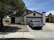 Single-story house with attached garage and a tree in the front yard at 3978 Tangerine Ct, Las Vegas, NV 89103