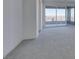 Living room with gray carpet and sliding glass doors leading to a balcony at 522 Riley Ridge Ct, Henderson, NV 89012