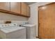 Laundry room with washer, dryer, and ample wooden cabinetry at 5423 Arturo Ct, Las Vegas, NV 89120