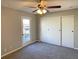 Bedroom with a large closet, balcony access, and ceiling fan at 7054 Burcot Ave # J43, Las Vegas, NV 89156