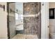 Modern bathroom with a walk-in shower and marble tile at 7378 Kayvani Ct, Las Vegas, NV 89117