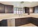 Kitchen featuring dark wood cabinets, stainless steel appliances, and a large window at 7378 Kayvani Ct, Las Vegas, NV 89117