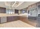 Kitchen with dark wood cabinets, stainless steel appliances, and a light-colored floor at 7378 Kayvani Ct, Las Vegas, NV 89117