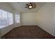 Bright bedroom with ceiling fan and large windows at 11076 Zampino St, Las Vegas, NV 89141