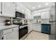 Clean and modern kitchen with white cabinets and teal appliances at 3151 Soaring Gulls Dr # 2110, Las Vegas, NV 89128