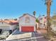 Two story house with red garage door and palm trees at 337 Warmside Dr, Las Vegas, NV 89145