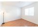 Simple bedroom with wood flooring and a large window at 4601 Skybolt St, Las Vegas, NV 89115