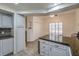 Eat-in kitchen with granite counters, white cabinets, and tile floors at 508 Indian Princess Dr # 101, Las Vegas, NV 89145