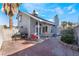 Brick paved patio, covered seating area, and mature landscaping create an inviting outdoor space at 6605 Messenger Ct, Las Vegas, NV 89108