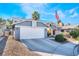 Two-story house with an attached garage and driveway at 6605 Messenger Ct, Las Vegas, NV 89108