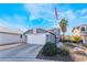 Two-story house with attached garage and landscaping at 6605 Messenger Ct, Las Vegas, NV 89108