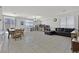 Spacious living room with a black leather sectional sofa and built-in shelving at 6678 Roanoke Ct, Las Vegas, NV 89148