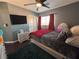 Spacious bedroom with hardwood floors, ceiling fan, and TV at 68 Jewel Mine Ave, Las Vegas, NV 89183