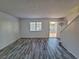 Bright living room with wood-look floors and access to stairway at 7089 Burcot Ave # A89, Las Vegas, NV 89156