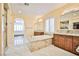 Elegant bathroom with double vanity, soaking tub, and views to backyard at 7293 Iron Oak Ave, Las Vegas, NV 89113