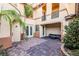 Private brick courtyard with seating area and palm trees at 7293 Iron Oak Ave, Las Vegas, NV 89113