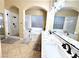 Elegant bathroom with marble finishes, double sinks, and a large shower at 7321 Gentle Valley St, Las Vegas, NV 89149