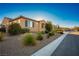 Tan house with gray shutters and desert landscaping at 8243 Twin Rock Ct, Las Vegas, NV 89113