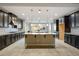 Modern kitchen with dark cabinetry, large island, and breakfast nook at 8243 Twin Rock Ct, Las Vegas, NV 89113