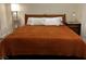 Inviting bedroom with wooden headboard, burnt orange bedding, and nightstands at 9133 Forest Willow Ave # 102, Las Vegas, NV 89149