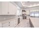 Elegant kitchen with white cabinetry, marble floors, and stainless steel appliances at 9805 Winter Palace Dr, Las Vegas, NV 89145