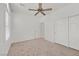 Bedroom with ceiling fan, neutral carpeting and sliding door to closet at 2426 Bedford Park Dr, Henderson, NV 89052