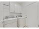 Laundry room with washer, dryer, and upper cabinets at 2426 Bedford Park Dr, Henderson, NV 89052