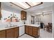 Galley kitchen features white appliances and wood cabinets at 319 Carrington St, Henderson, NV 89074