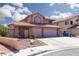 Two-story house with three-car garage and desert landscaping at 3326 Diego Bay Cir, Las Vegas, NV 89117