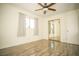 Bright bedroom with mirrored closet doors and wood-look floors at 4055 Syracuse Dr, Las Vegas, NV 89121