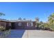 View of the home's side, showcasing solar panels and desert landscaping at 4055 Syracuse Dr, Las Vegas, NV 89121