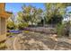 Landscaped backyard with gravel and mature trees at 4371 Angelo Rosa St, Las Vegas, NV 89135