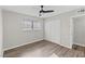 Well-lit bedroom with wood-look floors, double closets and ceiling fan at 4974 Lana Dr, Las Vegas, NV 89121