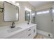 Modern bathroom with double vanity, quartz countertop and grey tile shower at 5228 El Pescador Ave, Las Vegas, NV 89108