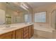 Bathroom boasts double sinks and a relaxing bathtub at 8904 Martin Downs Pl, Las Vegas, NV 89131