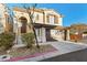 Two-story house with a brown door and attached garage at 9490 Swiftwater Ct, Las Vegas, NV 89178