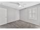 Spacious bedroom with ceiling fan, window with shutters, and neutral color palette at , North Las Vegas, NV 89084