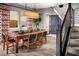 Modern dining room with a wood table and geometric patterned curtains at 10363 Vista Argento Ave, Las Vegas, NV 89166