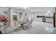 Open concept kitchen and dining area with stainless steel appliances and white cabinets at 11117 Romola St, Las Vegas, NV 89141