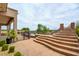 Inviting pool area with a stone staircase and lush landscaping at 18 Wade Hampton Trl, Henderson, NV 89052