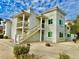 Exterior view of a white condo building with balconies and landscaping at 1904 Las Palmas Ln # 203, Laughlin, NV 89029